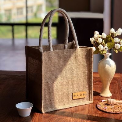 Milieuvriendelijke jute winkeltassen met op maat gedrukt logo en leren handgrepen
